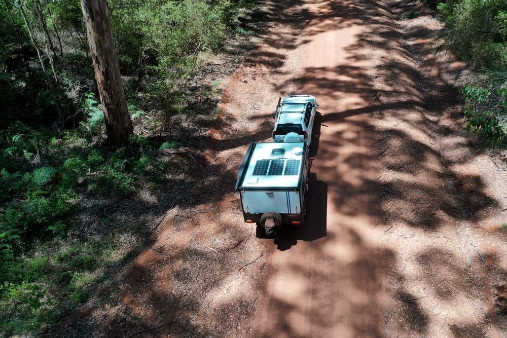 An Aerial View of a Truck Pulling a Trailer Down a Dirt Road — 365 Towing Taree in Forster, NSW