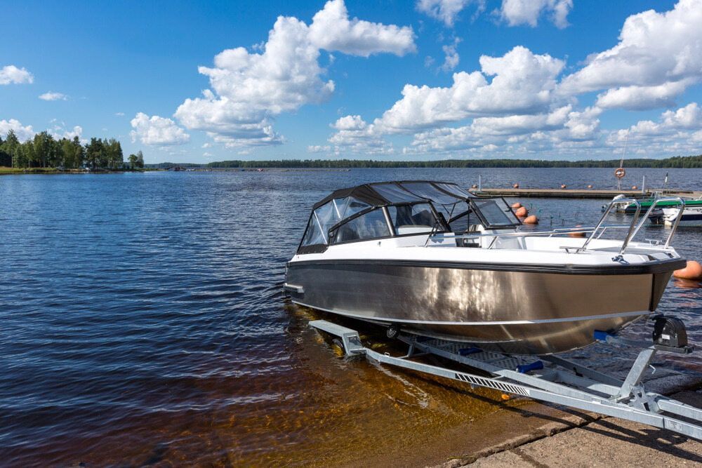Boat is Sitting on a Trailer in the Water — 365 Towing Taree in Oldbar, NSW