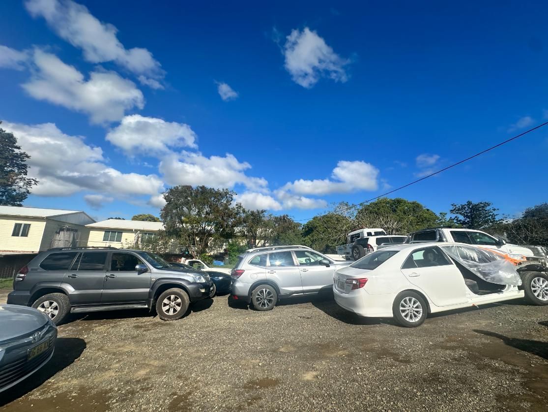 Row of Cars Are Parked in a Gravel Lot — 365 Towing Taree in Taree, NSW