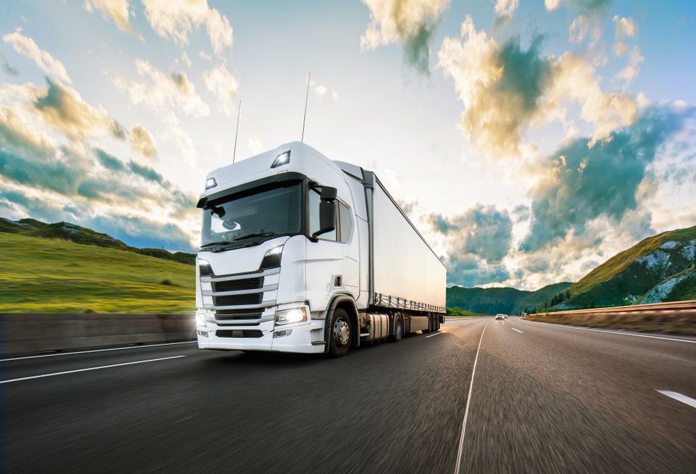 White Semi Truck is Driving Down a Highway — 365 Towing Taree in Forster, NSW