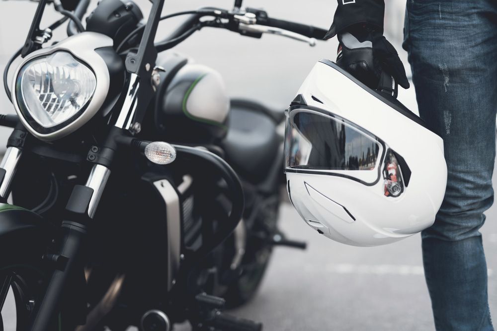 Person is Holding a Helmet Next to a Motorcycle — 365 Towing Taree in Forster, NSW