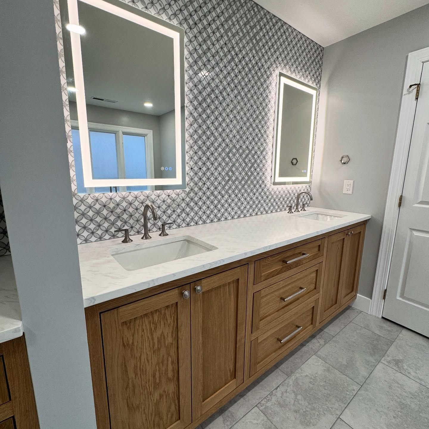 A bathroom with two sinks and two mirrors.