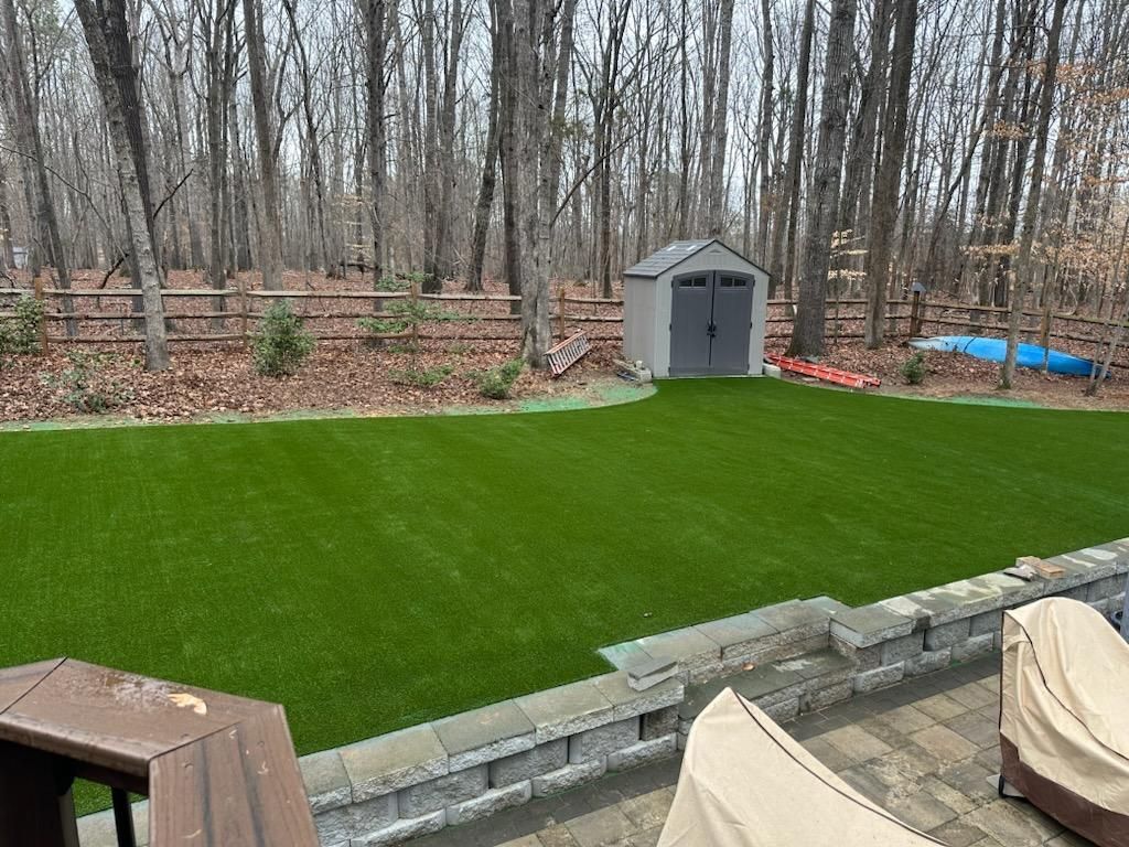 artificial grass installed in backyard of Raleigh NC home next to back patio