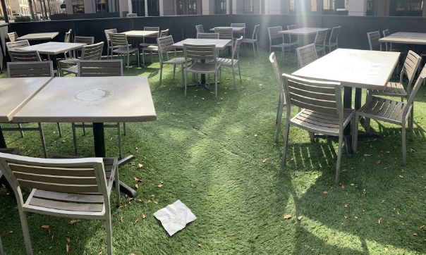 An upscale restaurant outdoor dining patio covered in realistic synthetic grass for businesses.