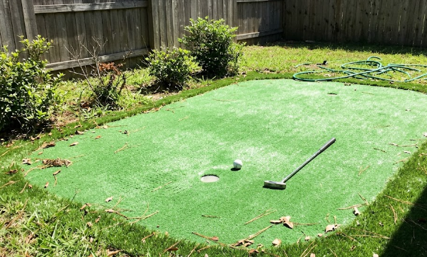 A custom artificial grass backyard putting green installed for a local home.