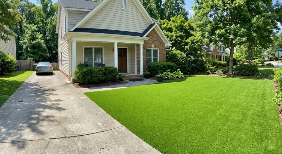Lush artificial grass installed in a beautiful Raleigh residential front yard.