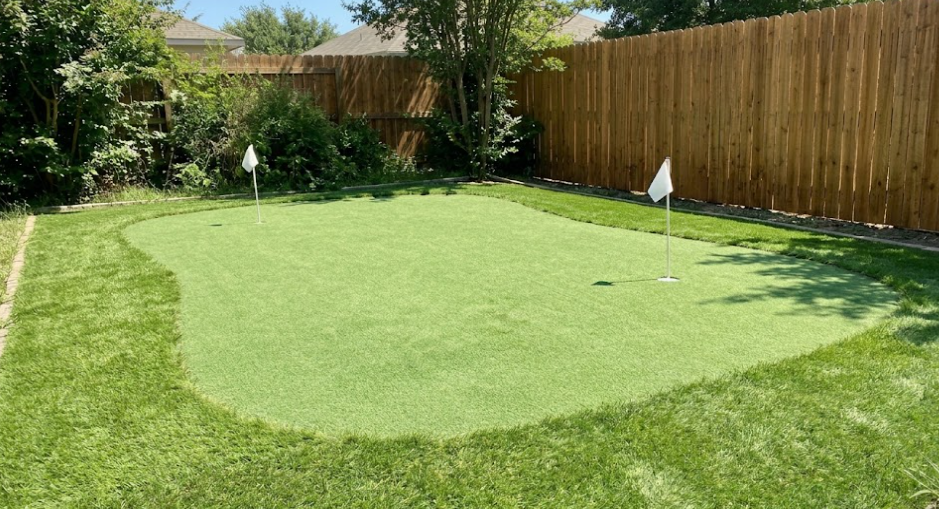 Custom artificial grass backyard putting green installation.