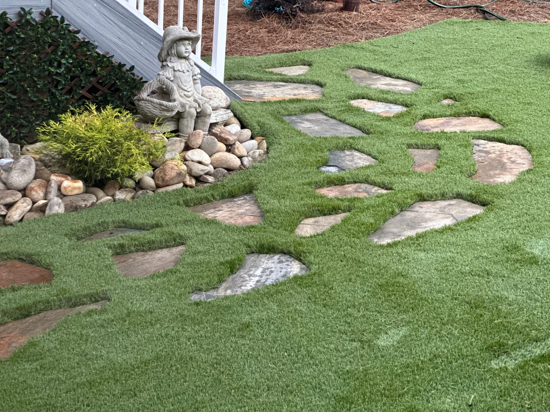 Hardscape walking path in synthetic grass installation in Chapel Hill NC