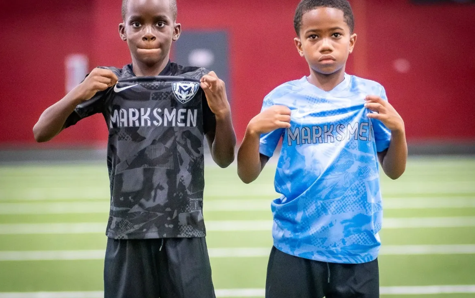Two DMV Marksmen players posing in jerseys