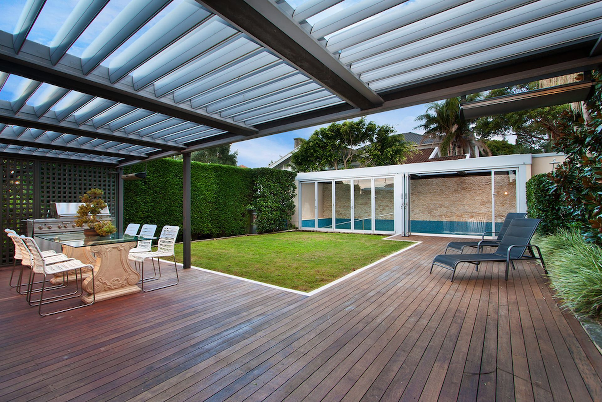 Wooden Patio with Pergola, Overlooking a Backyard with Green Grass — CAW Services in Badagarang, NSW