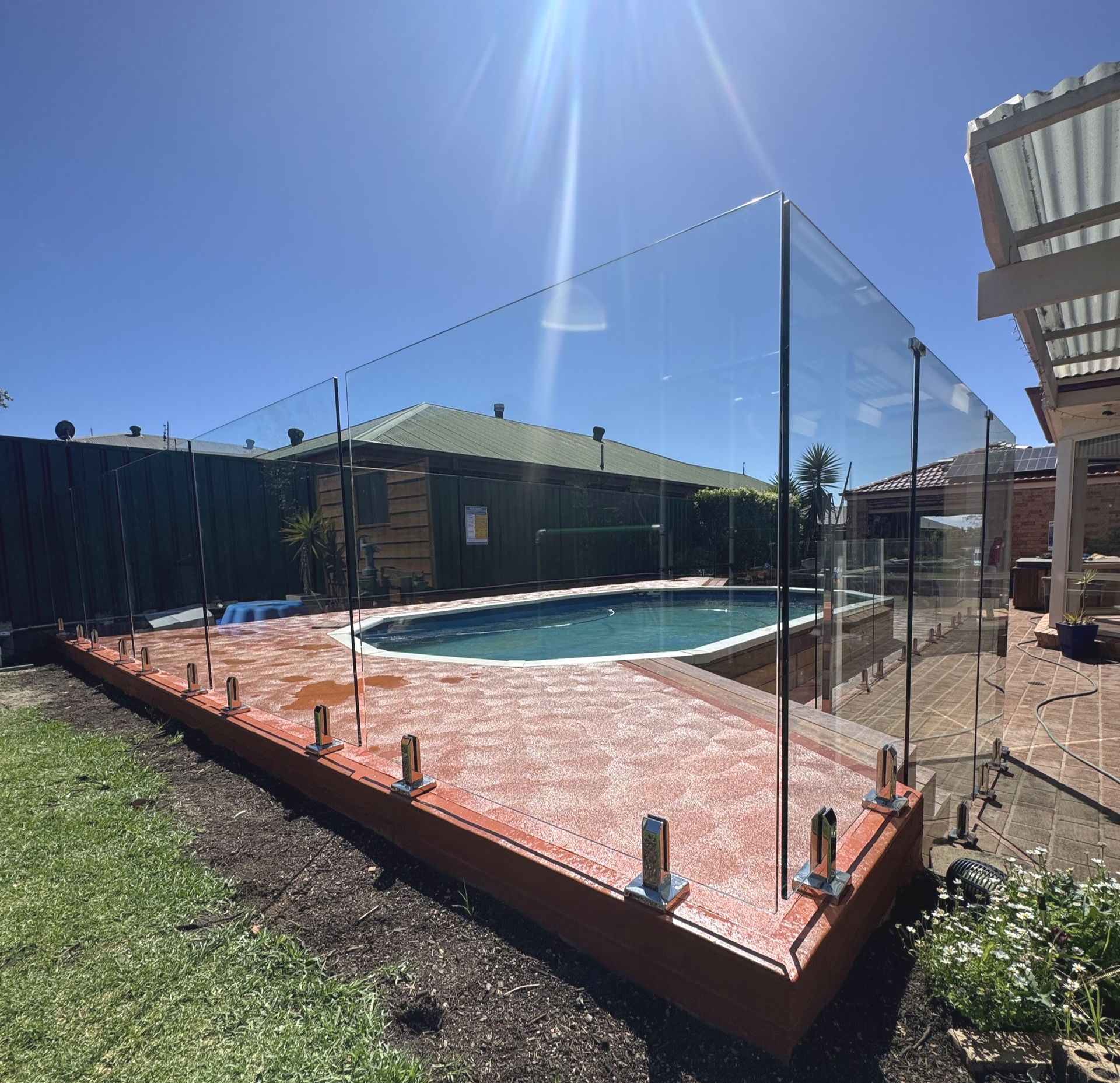 Beige fence damaged and leaning over; green trees and grass in background under overcast sky — CAW Services in Badagarang, NSW