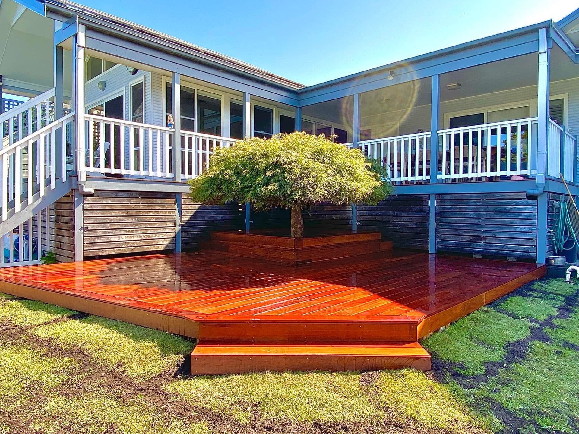Wooden Deck Extending from A House with Large Windows — CAW Services in Badagarang, NSW