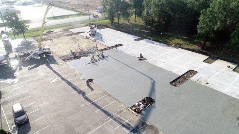 An aerial view of a building under construction in a parking lot.