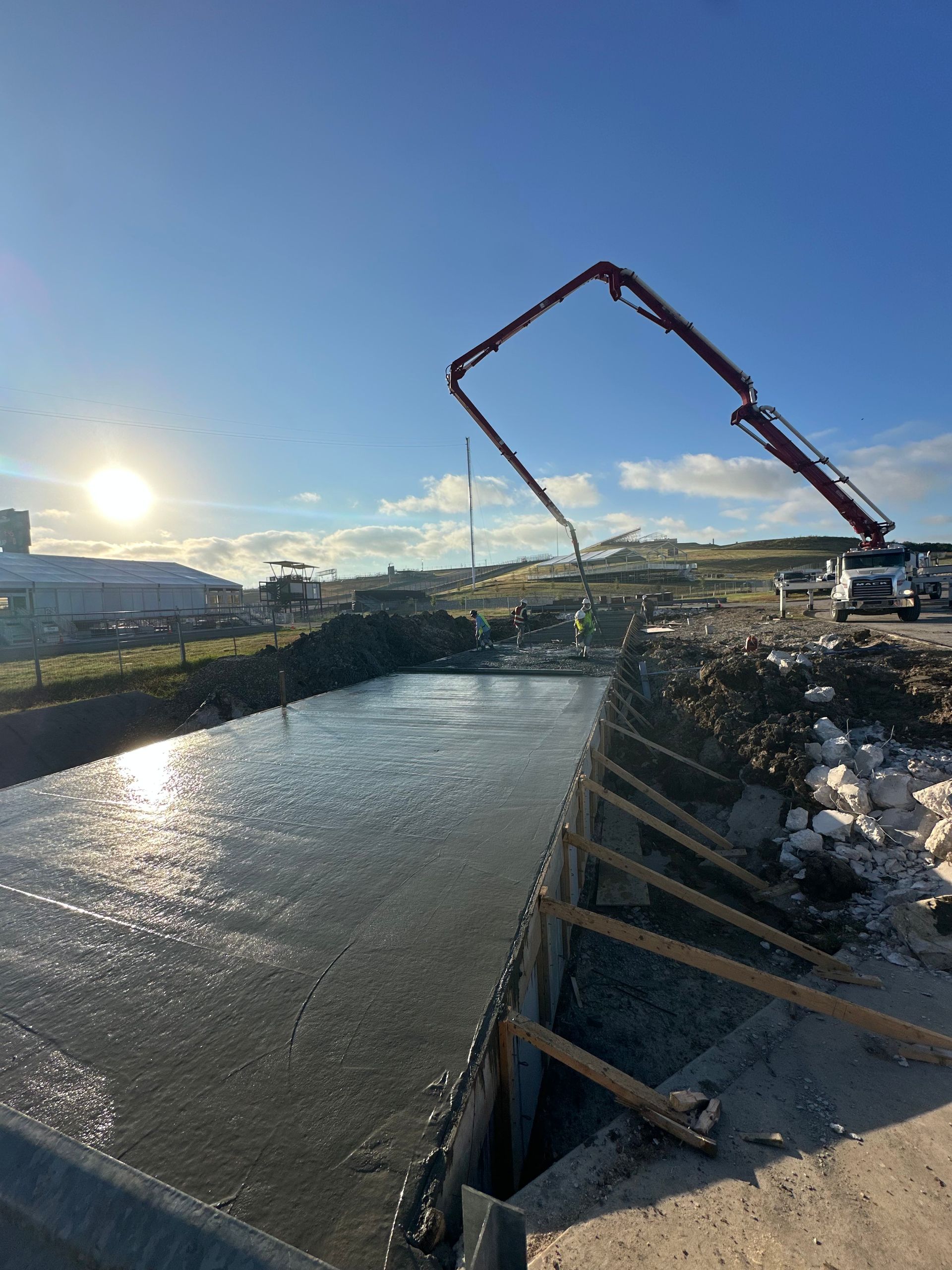 A concrete pump is pouring concrete into a large body of water.
