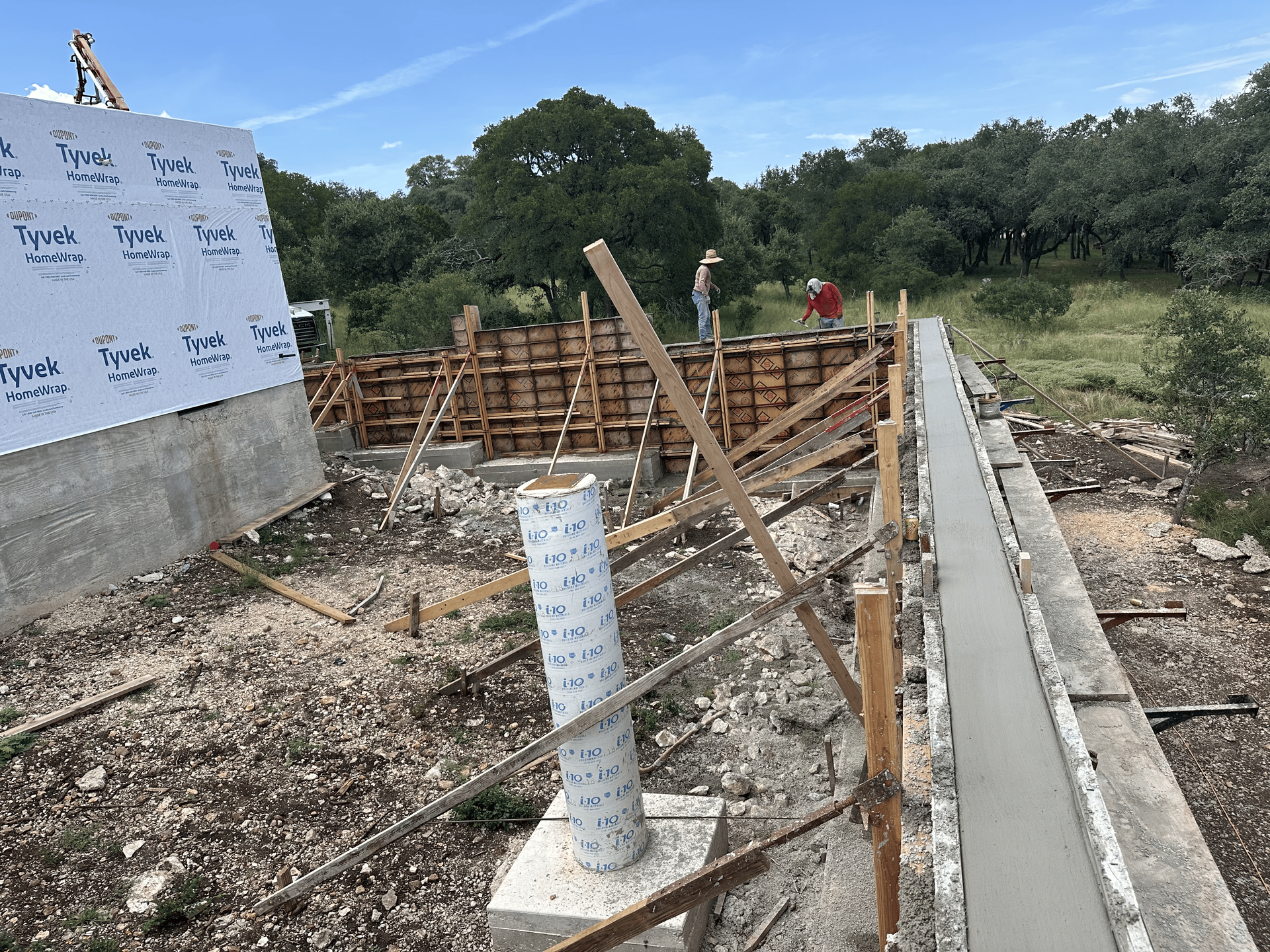 Construction site with concrete forms and workers.