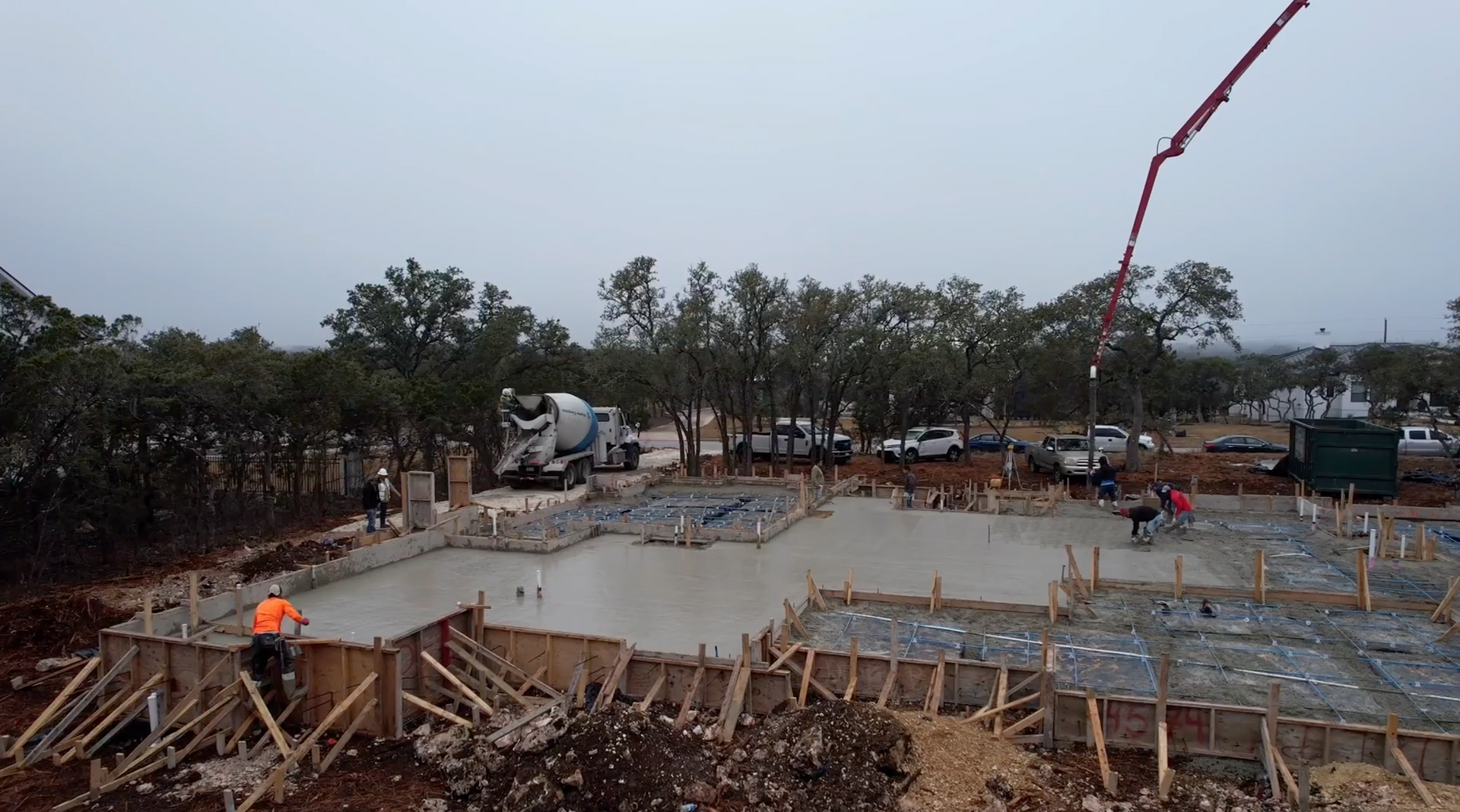A concrete pump is pouring concrete on a construction site