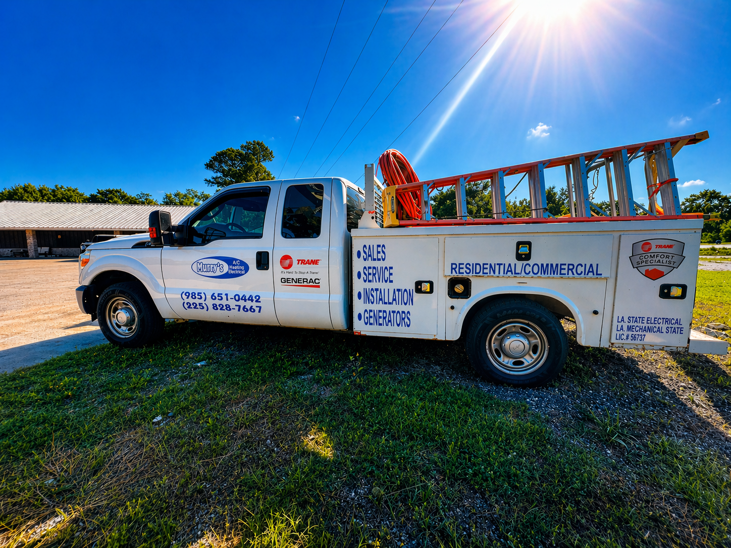 White utility truck with ladder parked on grass under bright sun, viewed from the side