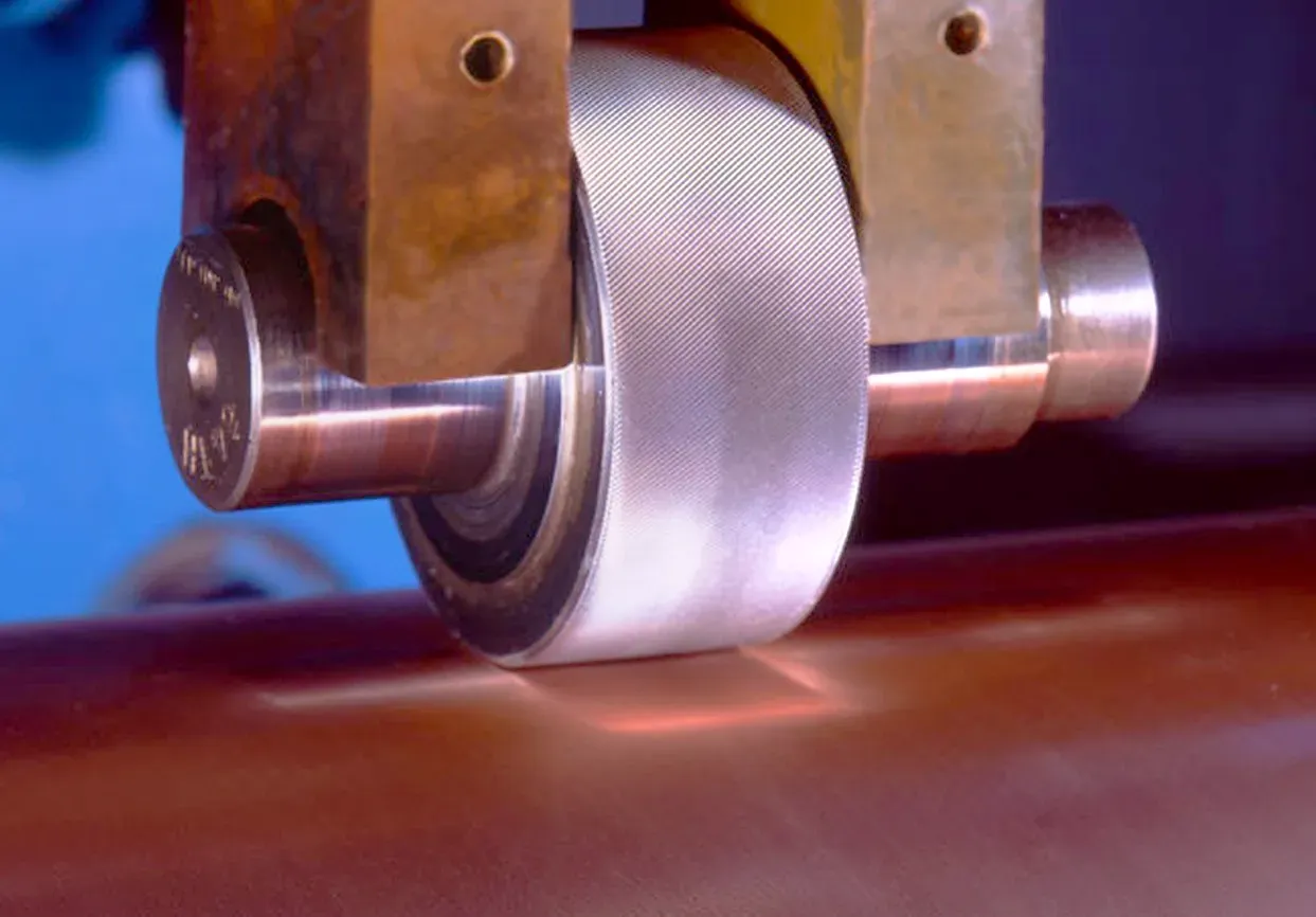 A close up of a metal wheel on a machine
