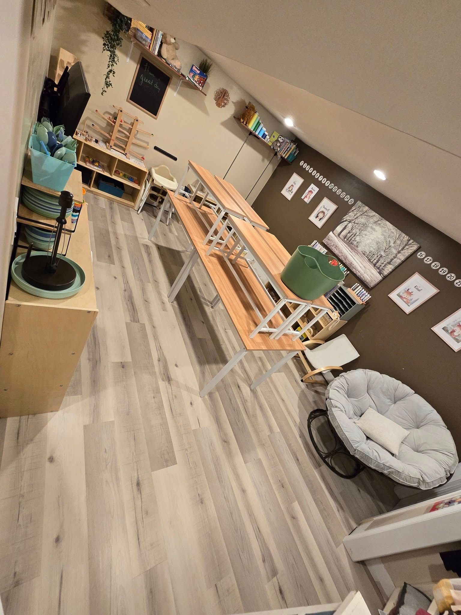 A room with a table , chairs , and a rocking chair.