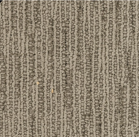 Close-up view of textured carpet in shades of gray and tan, with a vertical ribbed pattern.