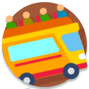 Colorful yellow and red bus with luggage on top, moving along a road