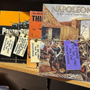 History books displayed on a shelf, including one titled “Napoleon in Europe,” with purple tags attached