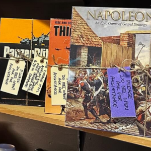 History books displayed on a shelf, including one titled “Napoleon in Europe,” with purple tags attached