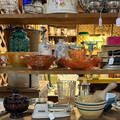 Shelves of colorful glass bowls and decorative dishes in a shop display