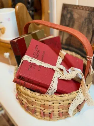 Basket of red books tied with lace on a table