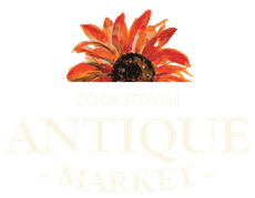 Cookstown Antique Market logo with orange-red flower above pale gold text on white background