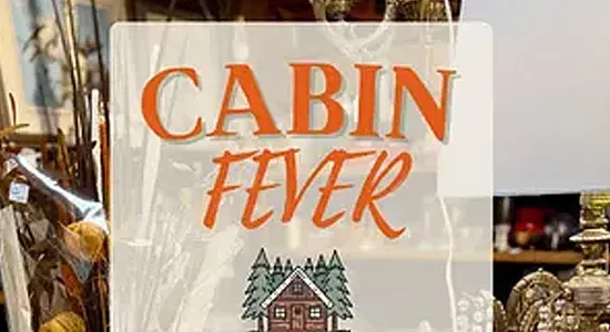 Cabin Fever sale sign with orange text, winter cabin graphic, and “10–50% off” on a shop window