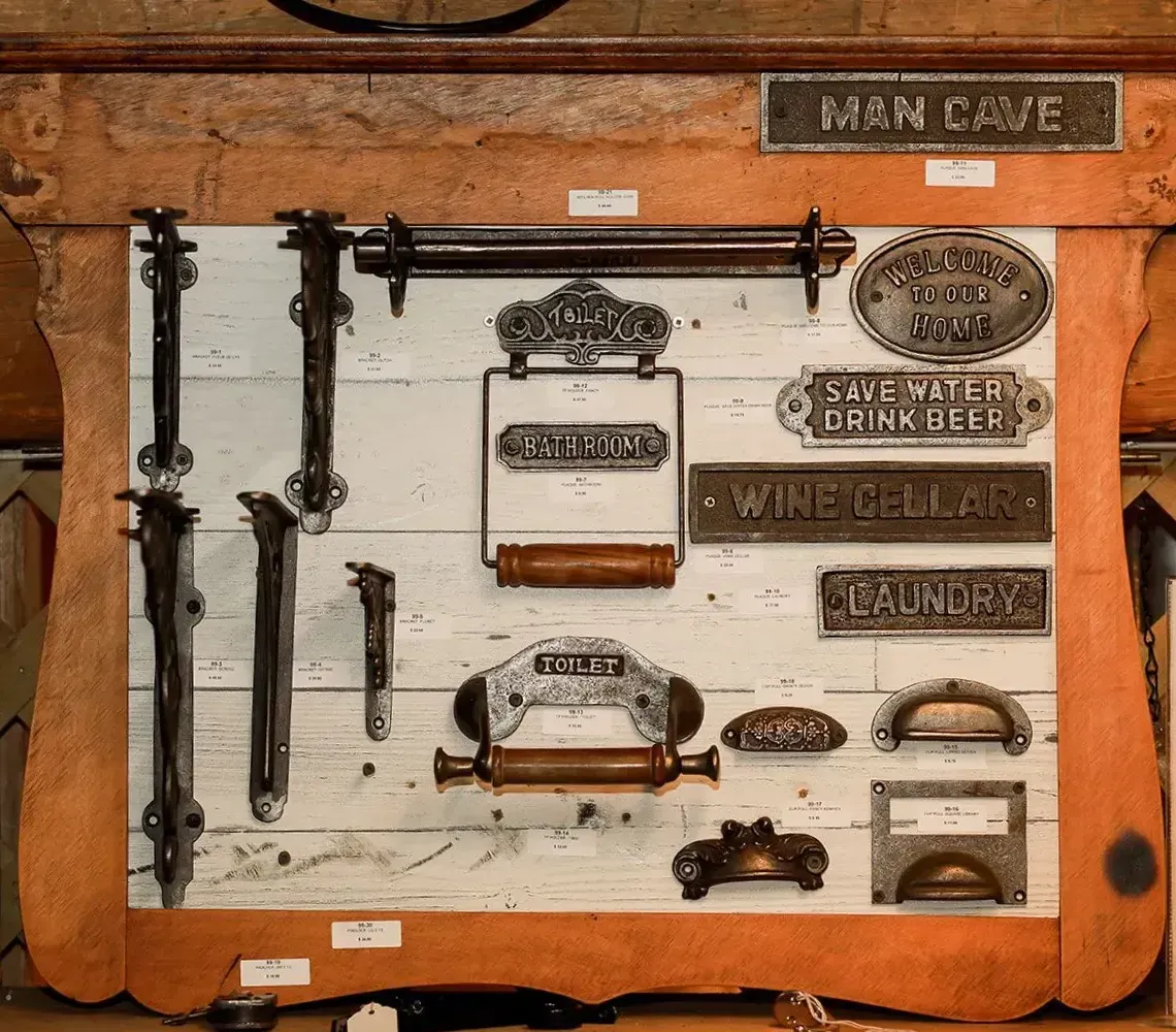Vintage tool display board with rusted metal parts mounted on a brown wooden panel