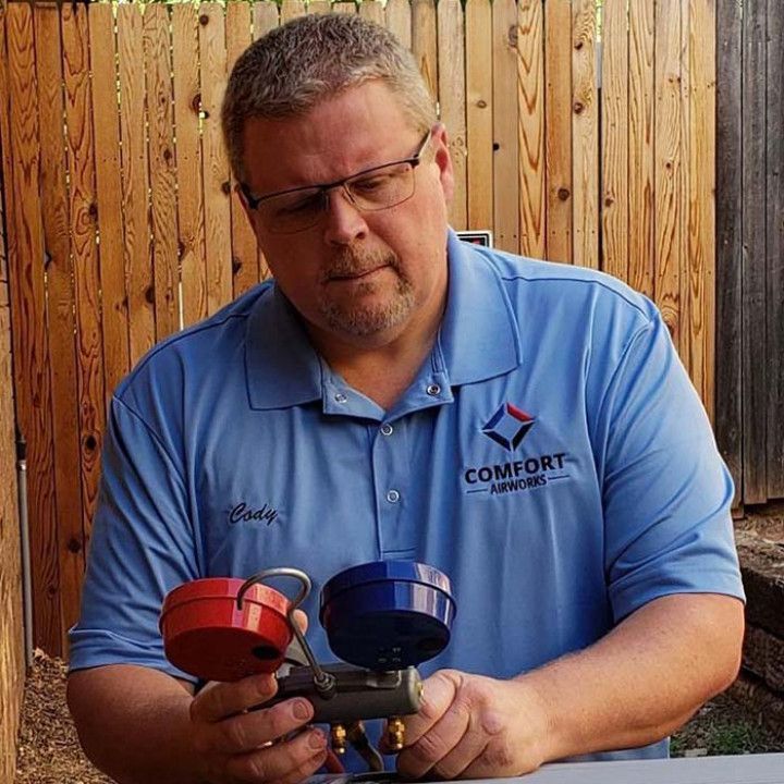 Cody is holding two valves in his hands.