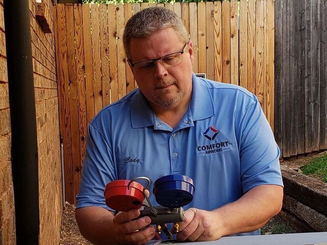 Cody is holding two valves in his hands.