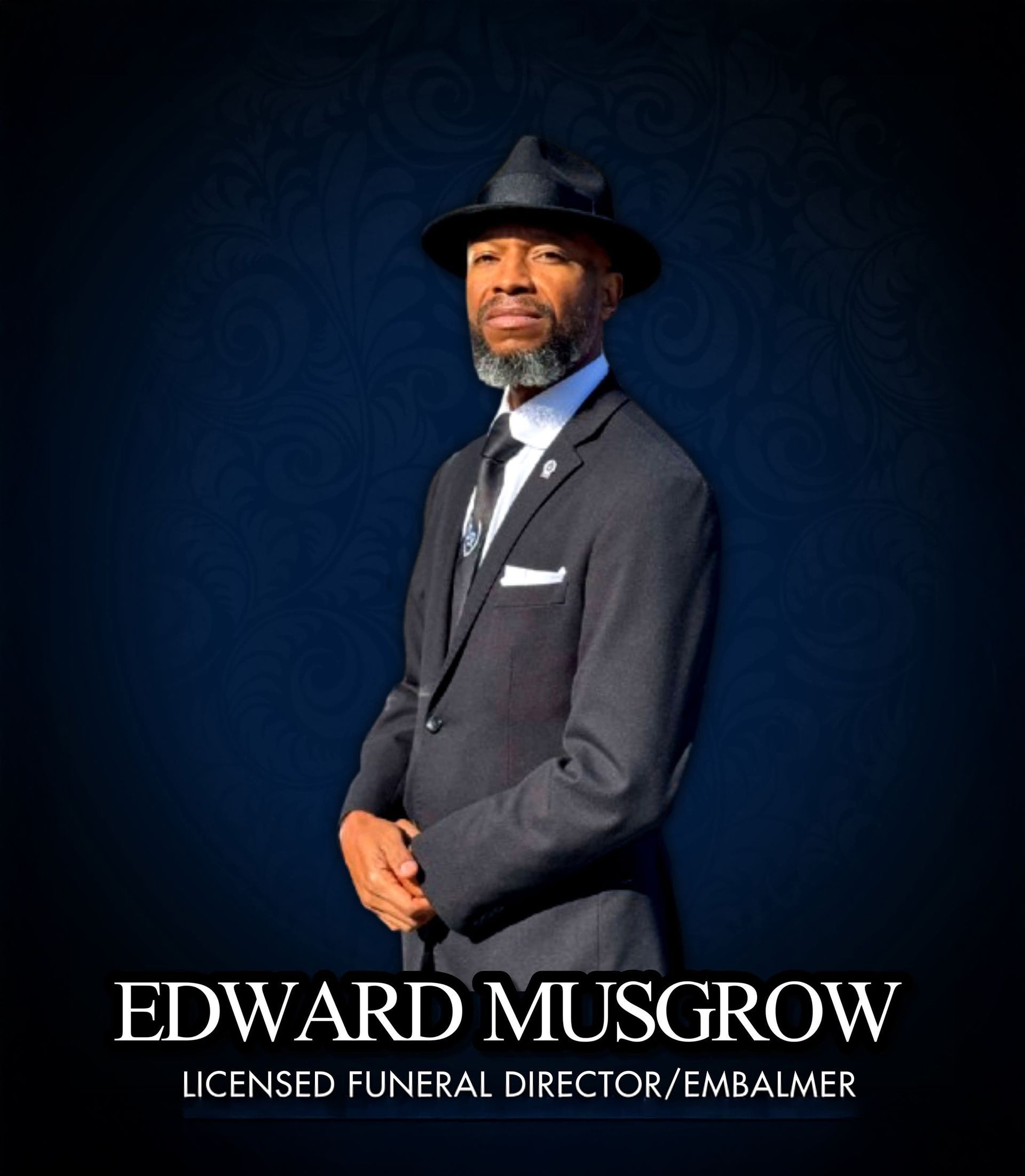 Portrait of Edward Musgrove in a dark suit and hat against a blue background, with his name below