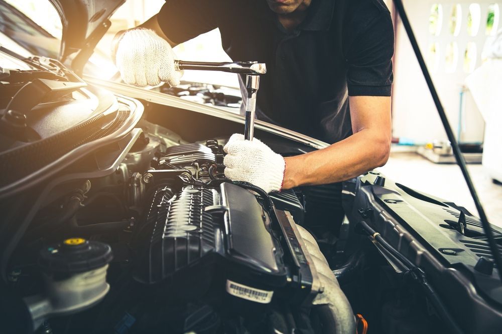 Auto Mechanic Repairing Car Engine