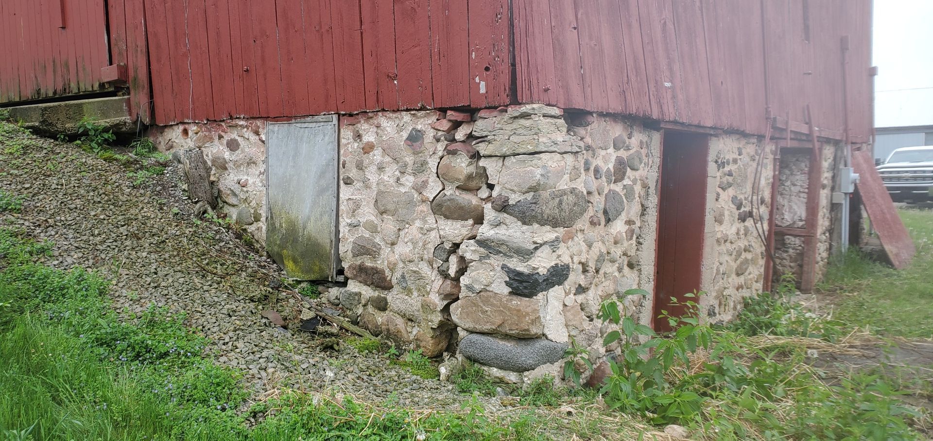 Red barn foundation made of stone. 
