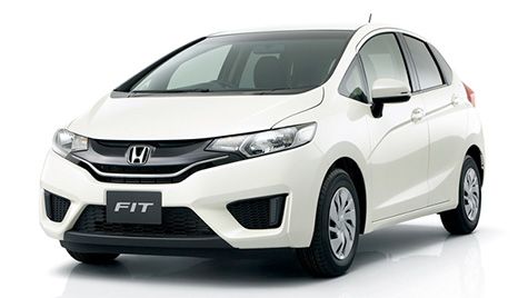 White Honda Fit hatchback on a white studio background, angled front view