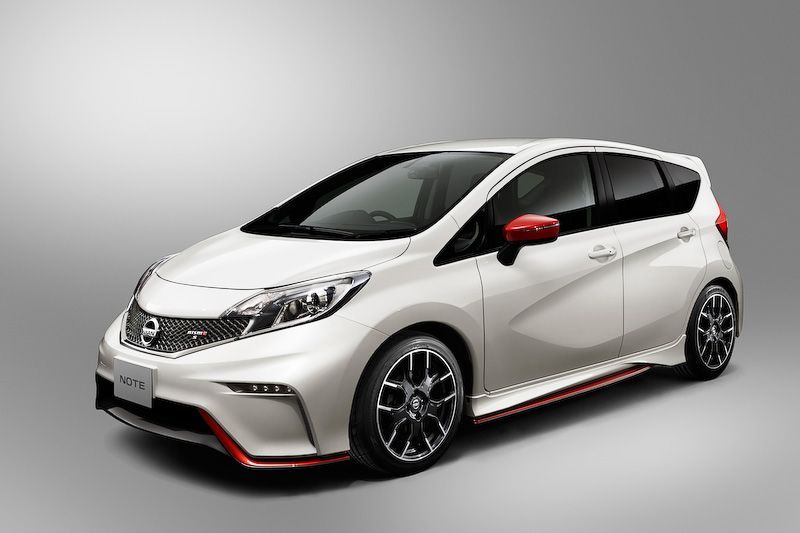 White sporty hatchback car with red accents on a gray studio background