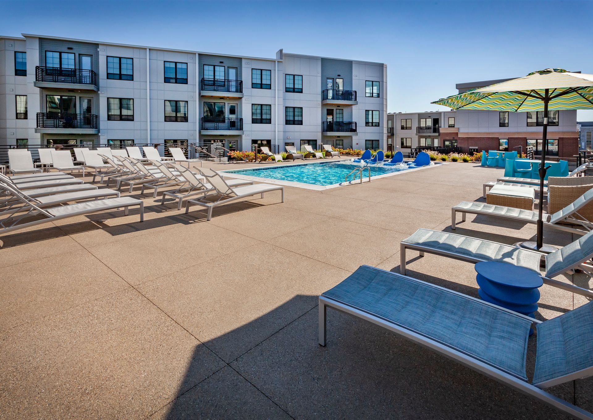 A large swimming pool surrounded by lounge chairs and umbrellas at Nickel Plate.