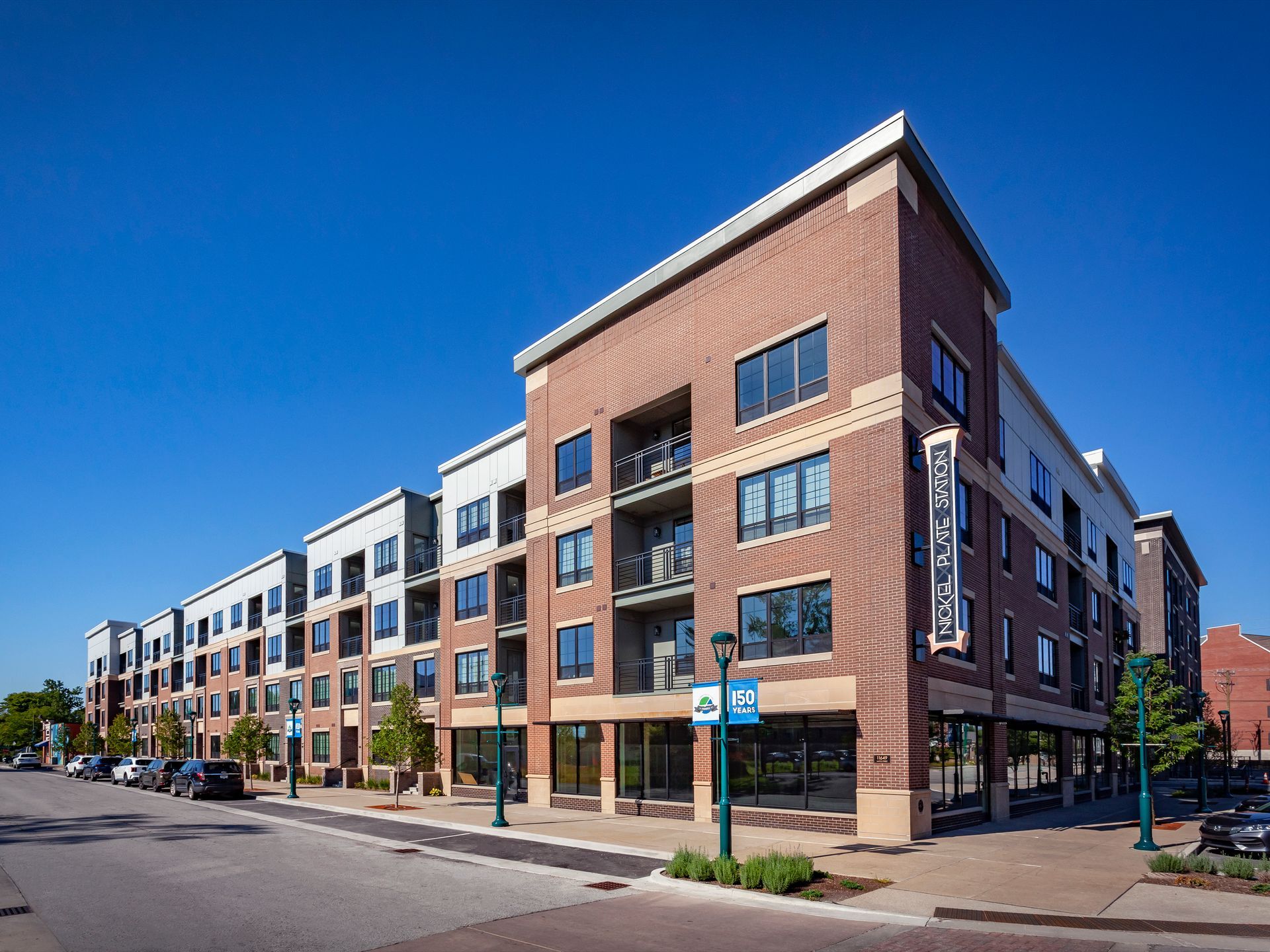 A large brick building with a lot of windows on a sunny day at Nickel Plate.