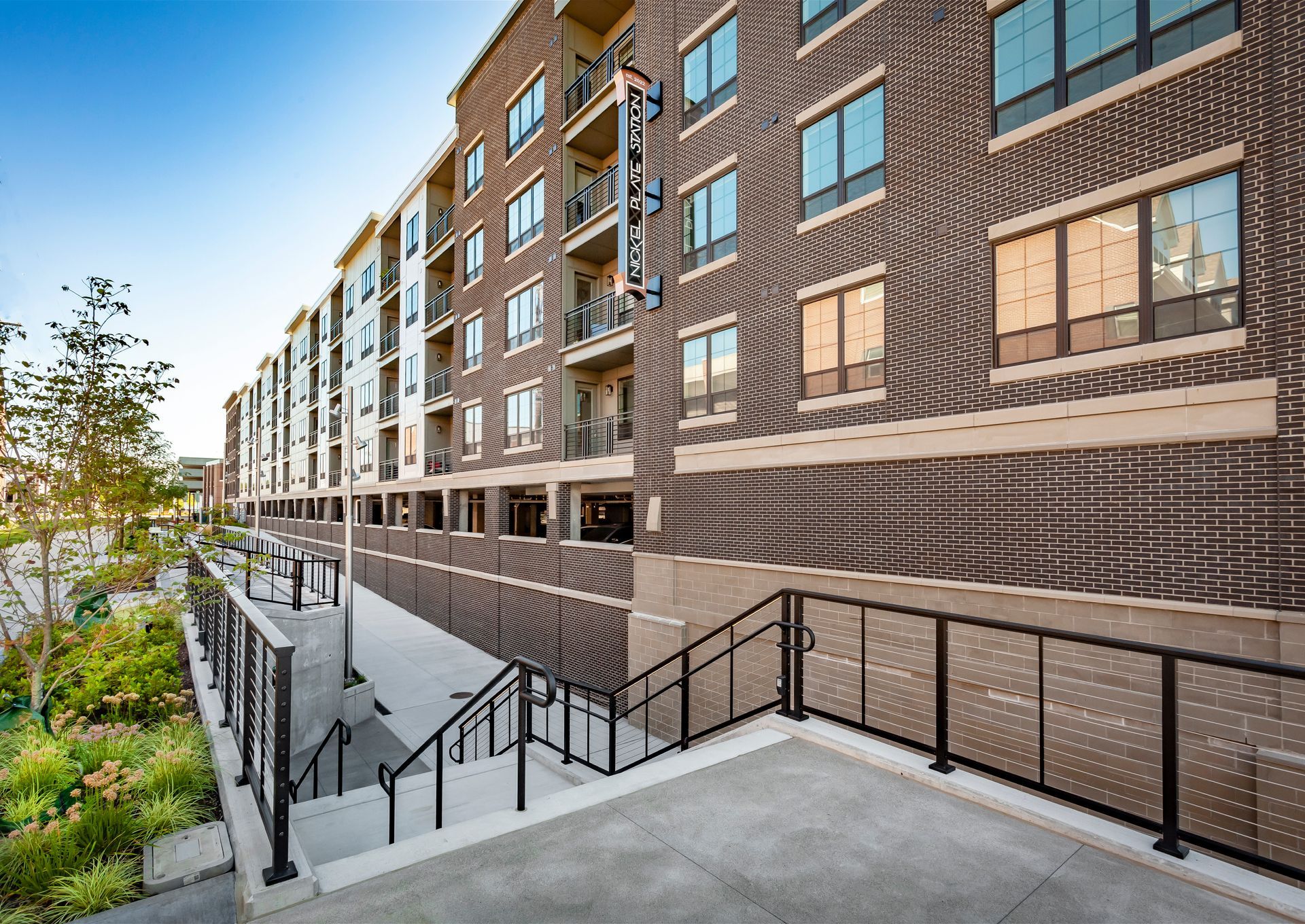 A large apartment building with stairs leading up to it at Nickel Plate.