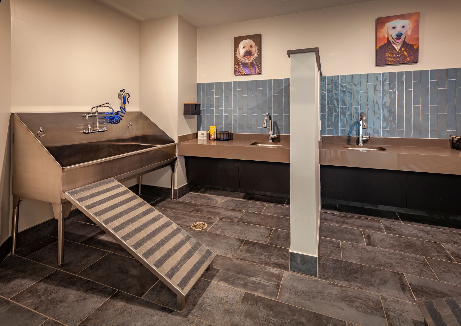 A dog wash room with a sink and stairs at Nickel Plate.