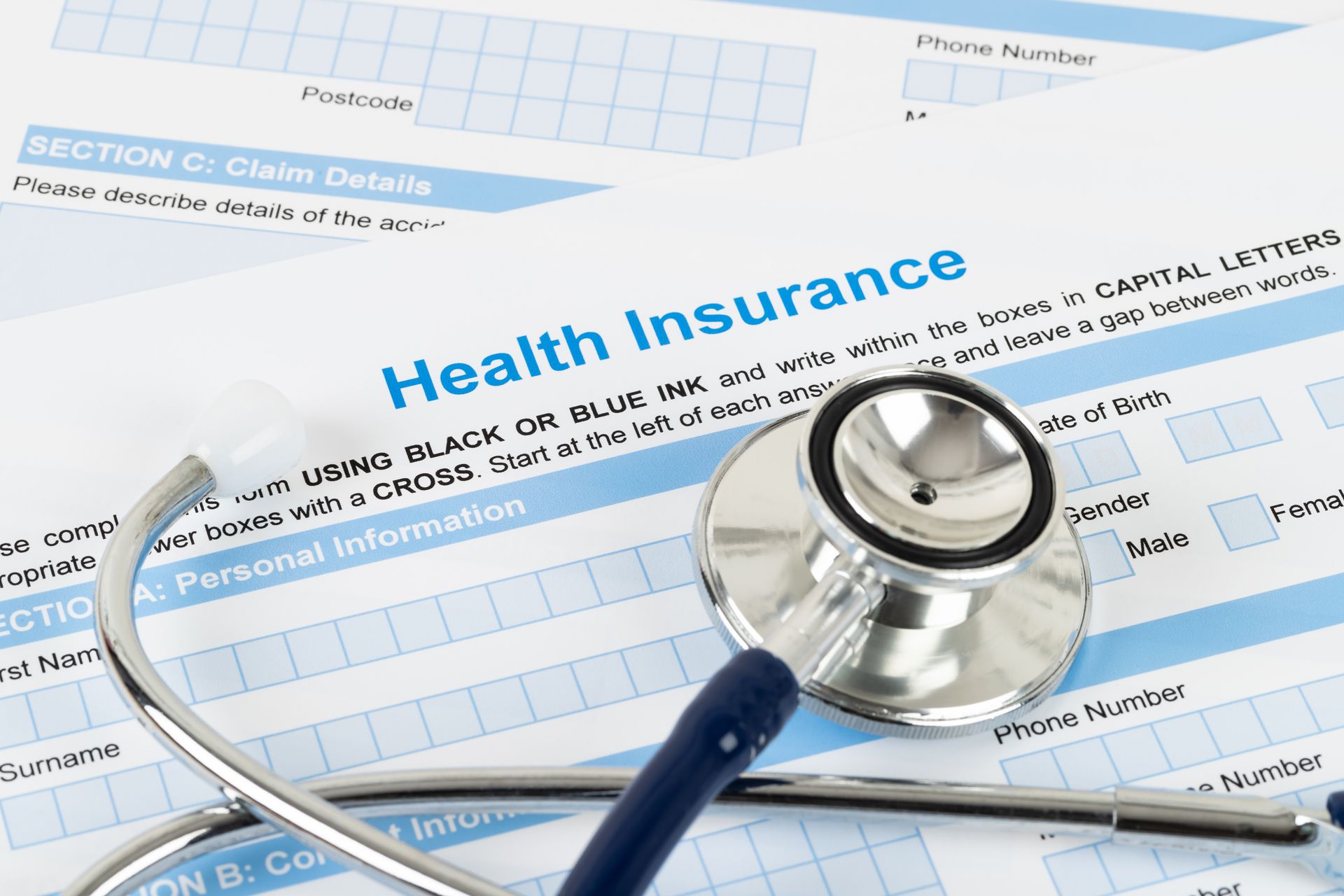 Health insurance forms with a stethoscope on top