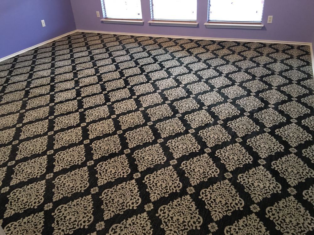 A black and white carpet in a room with purple walls