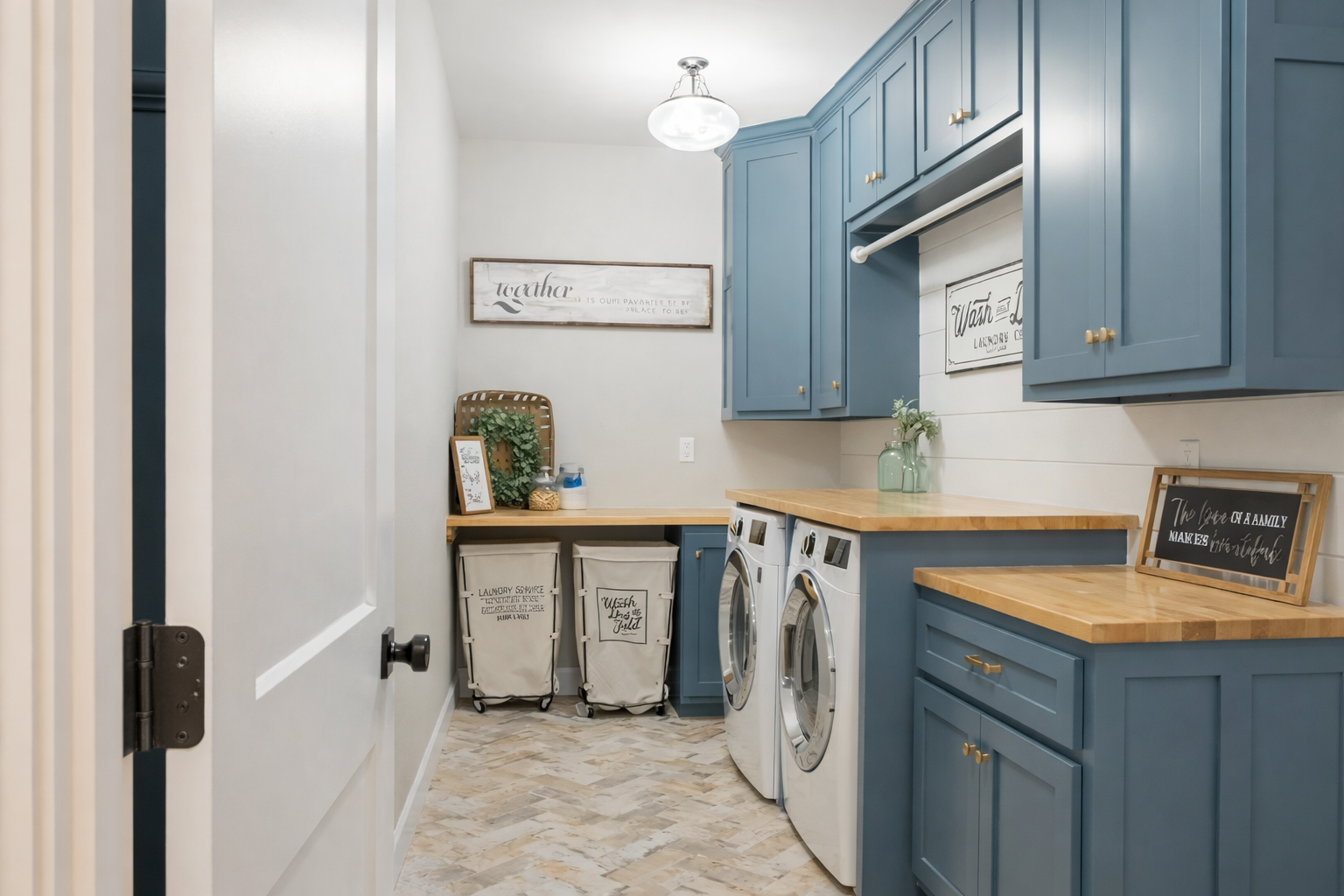 Blue laundry room with cabinets, appliances, wooden countertop, and decor — Paul Tagget Kitchens In Goonellabah, NSW