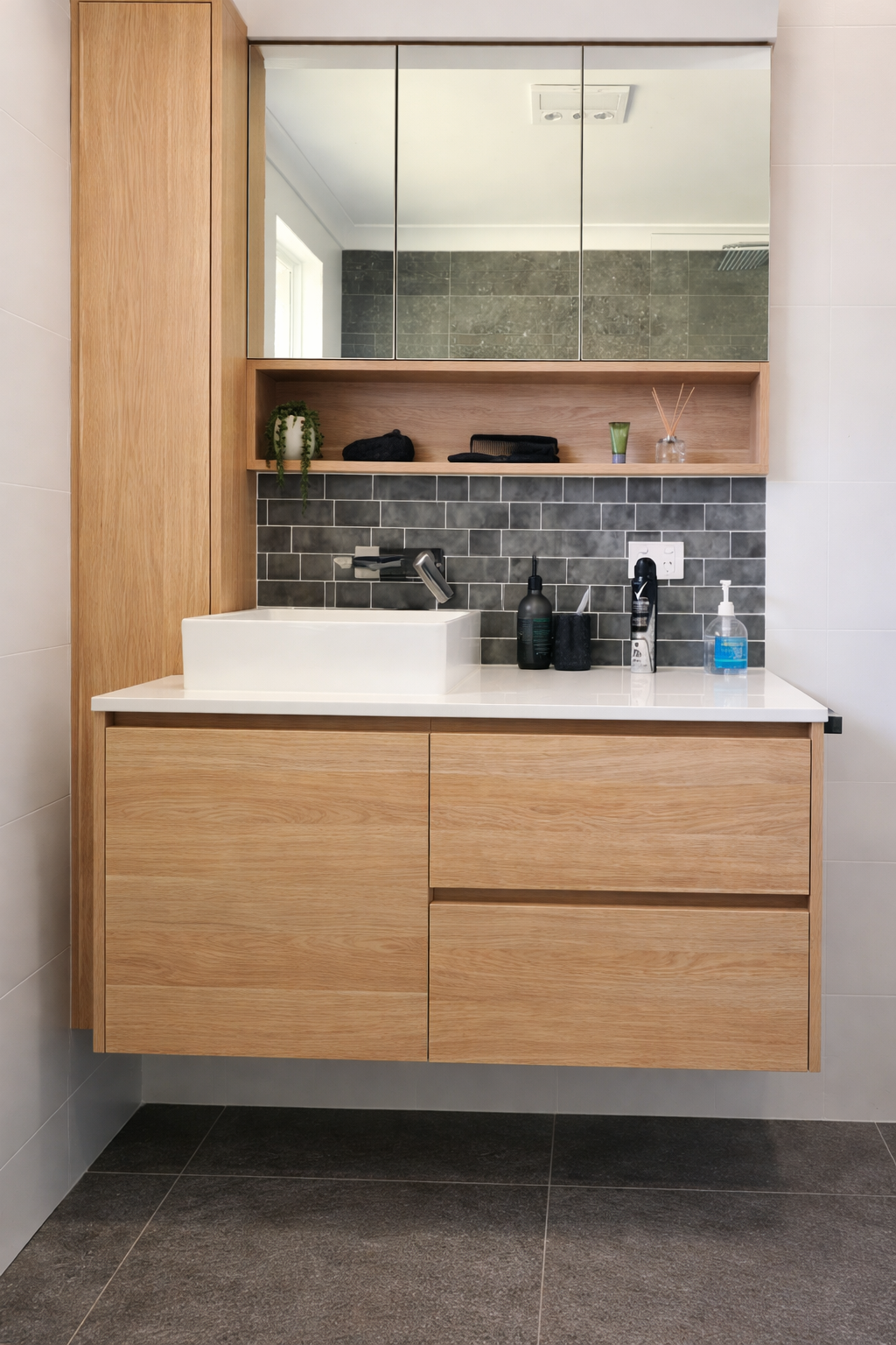Bathroom with Two White Bowl Sinks on A Black Countertop, Gold Mirrors, and Sconces — Paul Tagget Kitchens In Goonellabah, NSW