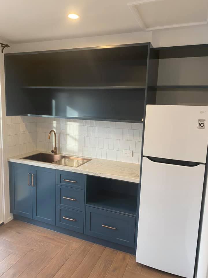 Compact Kitchen With Dark Blue Cabinets