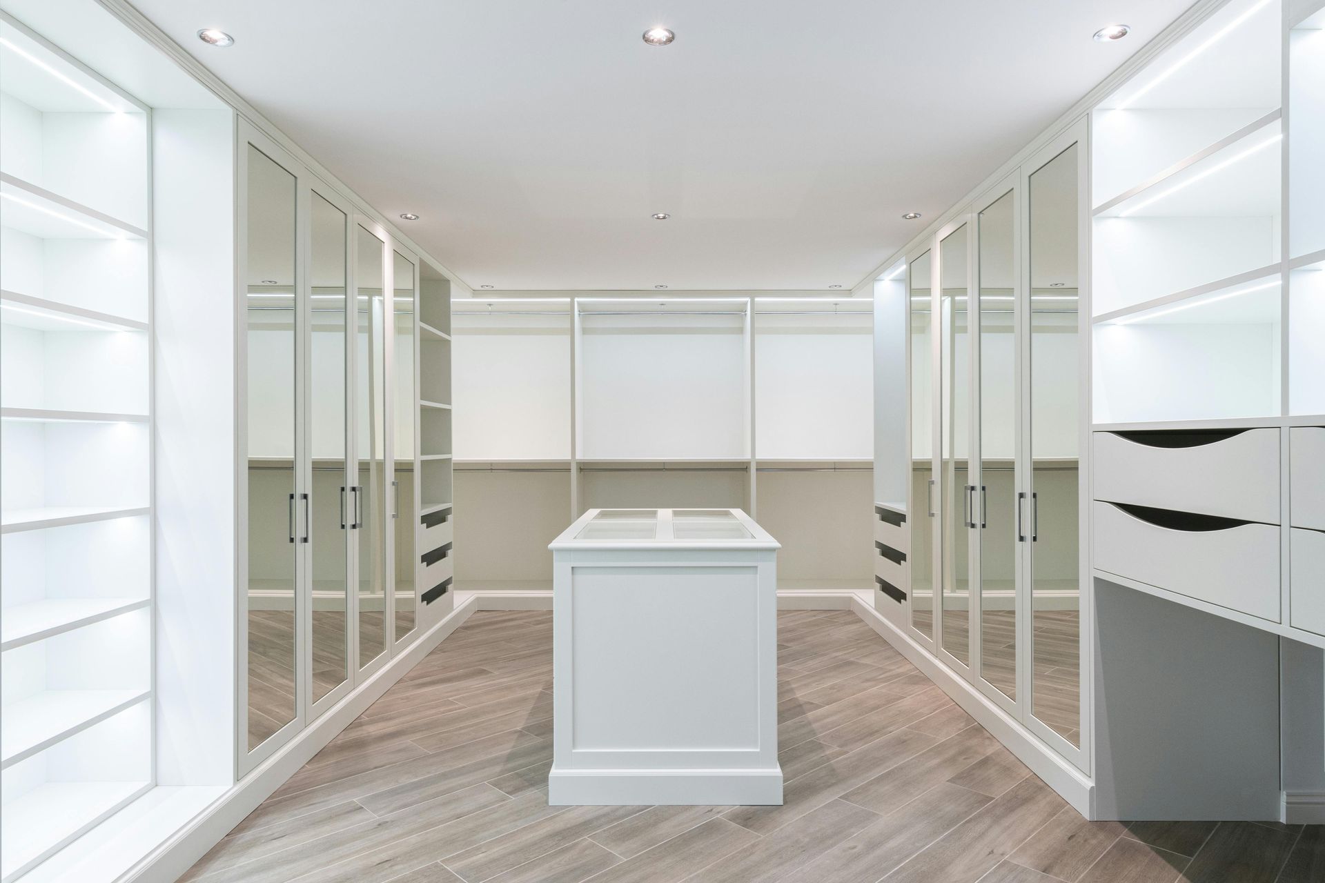 Bedroom with Glass-Door Closet, Wooden Accent Wall, and A Bed with Light Bedding — Paul Tagget Kitchens In Northern Rivers, NSW