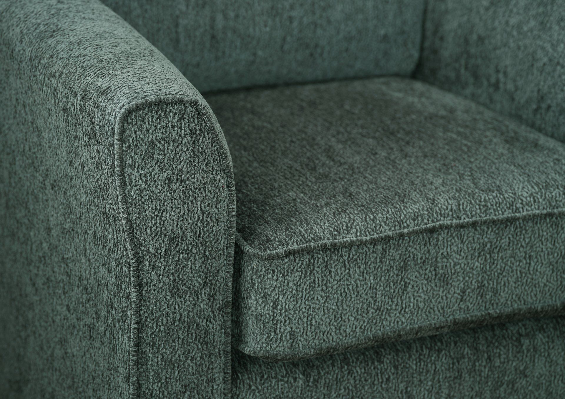 A close up of the arm of a grey chair.